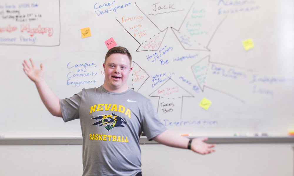 Jack standing in front of a white board