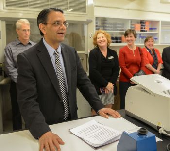 People listen to remarks being delivered at lab opening