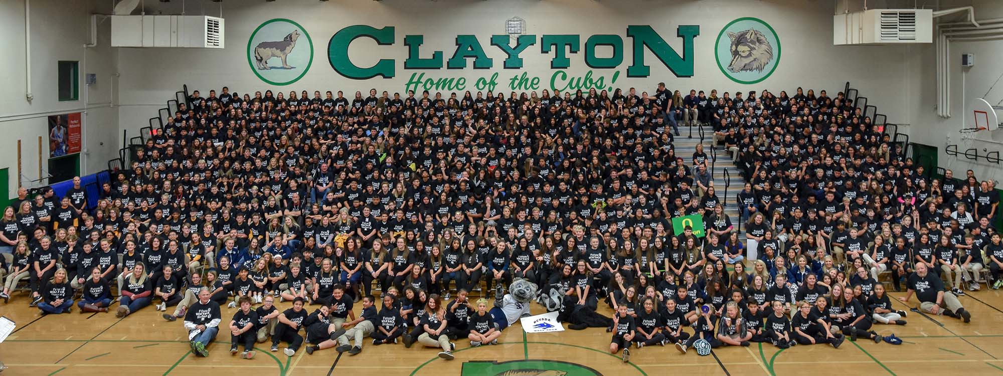 Clayton Middle School students pose for an all-school photo in new, black T-shirts at a College Day pep rally