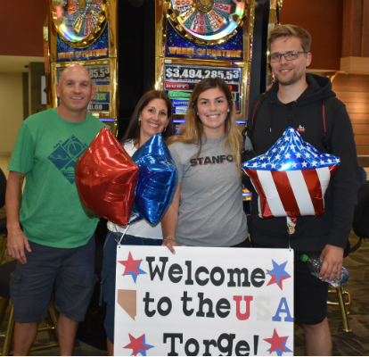 Gelard is greeted by his host family at the airport