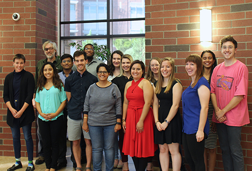 Fifteen scholarship recipients smiling together