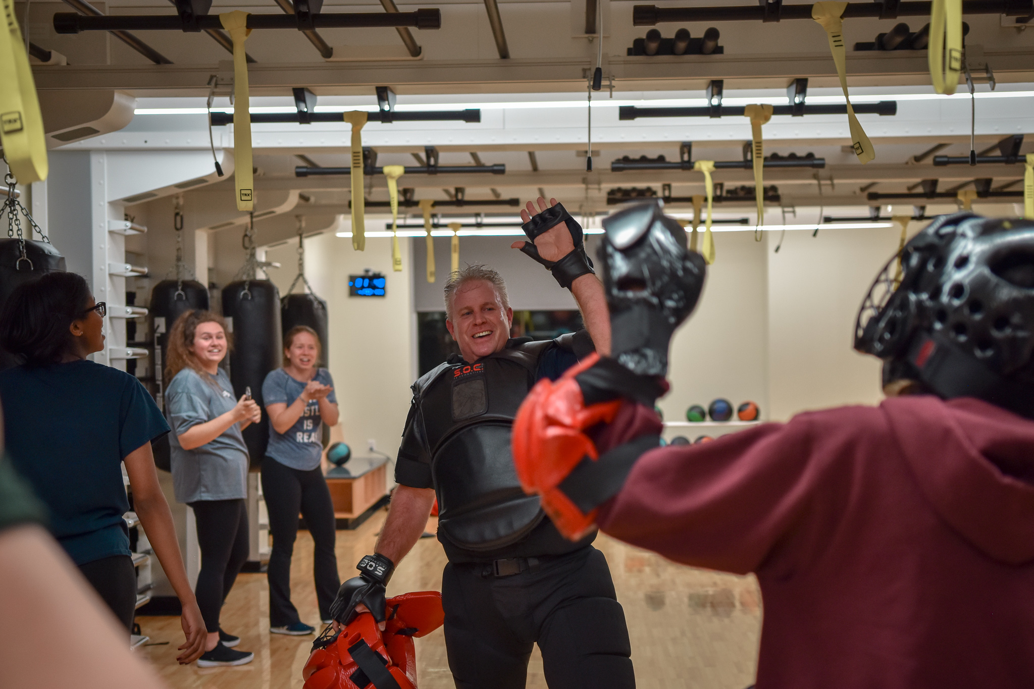 University Police Services Commander Eric James high-fiving a student.