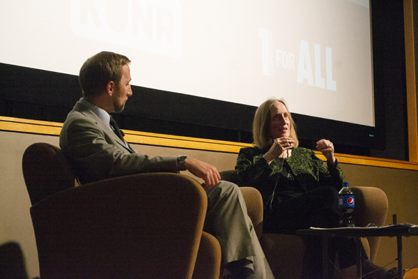 Man and woman sit on stage.