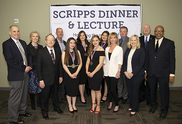 Members of the Scripps Family, Scripps scholarship recipients, university faculty and the Scripps speaker pose indoors.