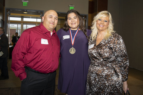 Scripps scholar and her family pose indoors.