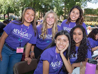 NevadaFIT HealthFIT students in purple shirts outside on the UNR Quad