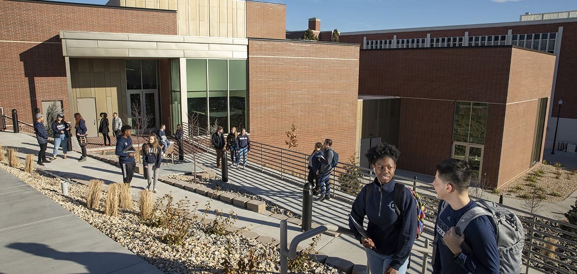 Students walking and talking outside the University Arts Building