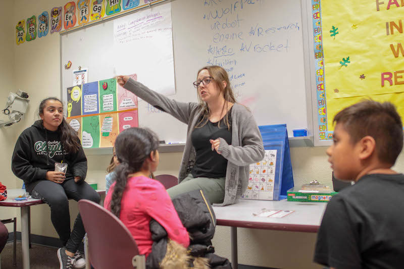 An undergraduate student teaching children about Lego Mindstorms.