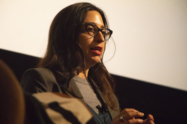 Woman speaks on stage.