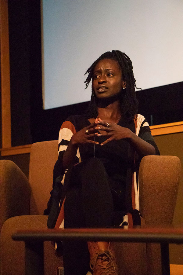 Woman speaks on stage.