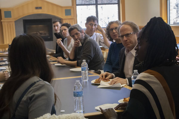 Faculty members listen to two women speaking in the Linn Reading Room.