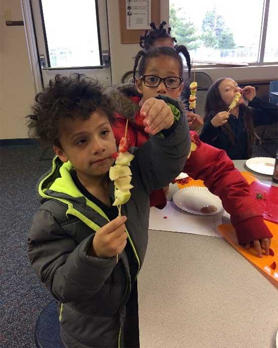 children making fruit kabobs