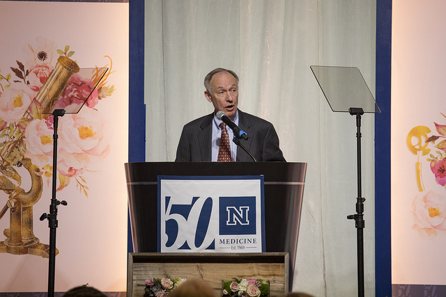 Dr. Tom Kozel, professor of microbiology and immunology, speaking at a podium