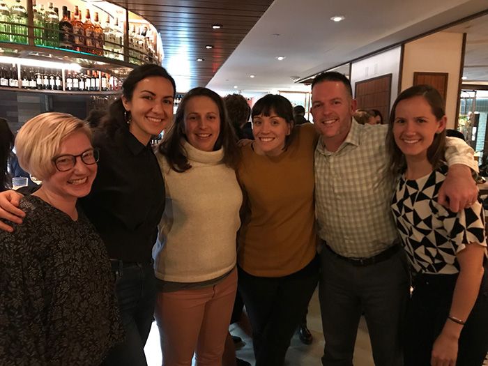 Group of people pose inside a restaurant