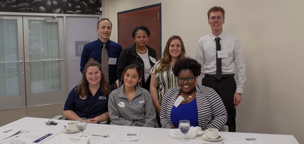 Students posing with faculty members at the event.