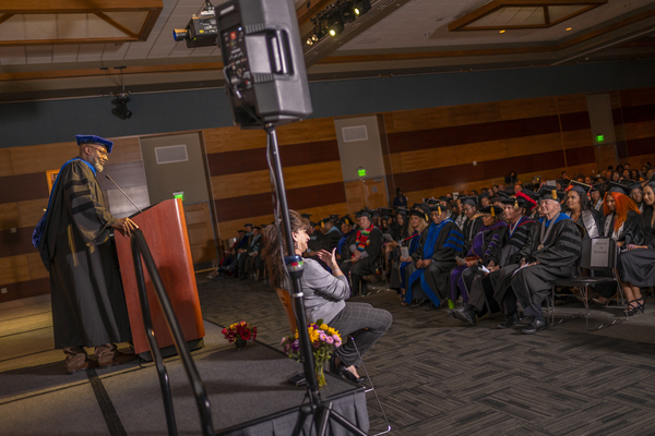 A speaker addressing the audience at the African Diapspora Graduate Celebration