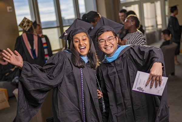 Two grads having a great time at the Asian American & Pacific Islander Graduate Celebration