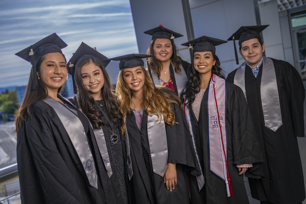 Graduates looking over the balcony outside the Latinx Graduate Celebration