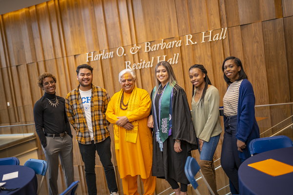 Graduates and faculty members laugh together at the Lavender Graduate Celebration