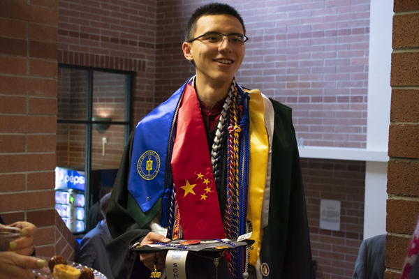 A student smiles indoors.