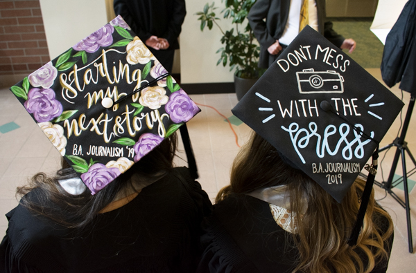The back of two graduation caps.