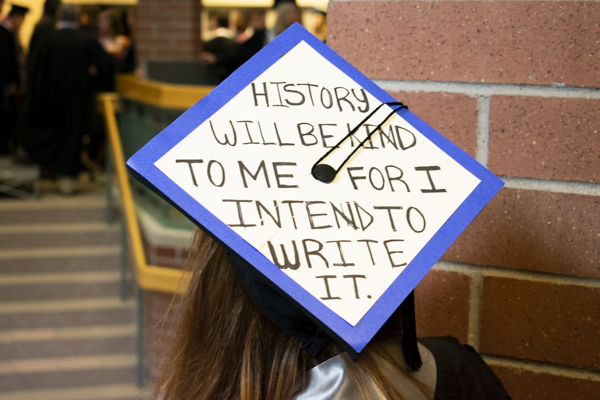 Back of a grad cap that reads, 'History will be kind to me for I intend to write it.'