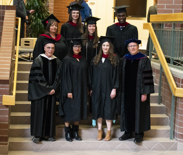 The graduate students pose in the atrium.