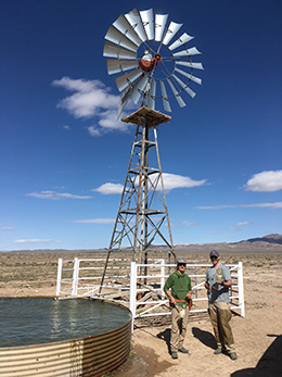 Warm well with grad students sampling for geochem