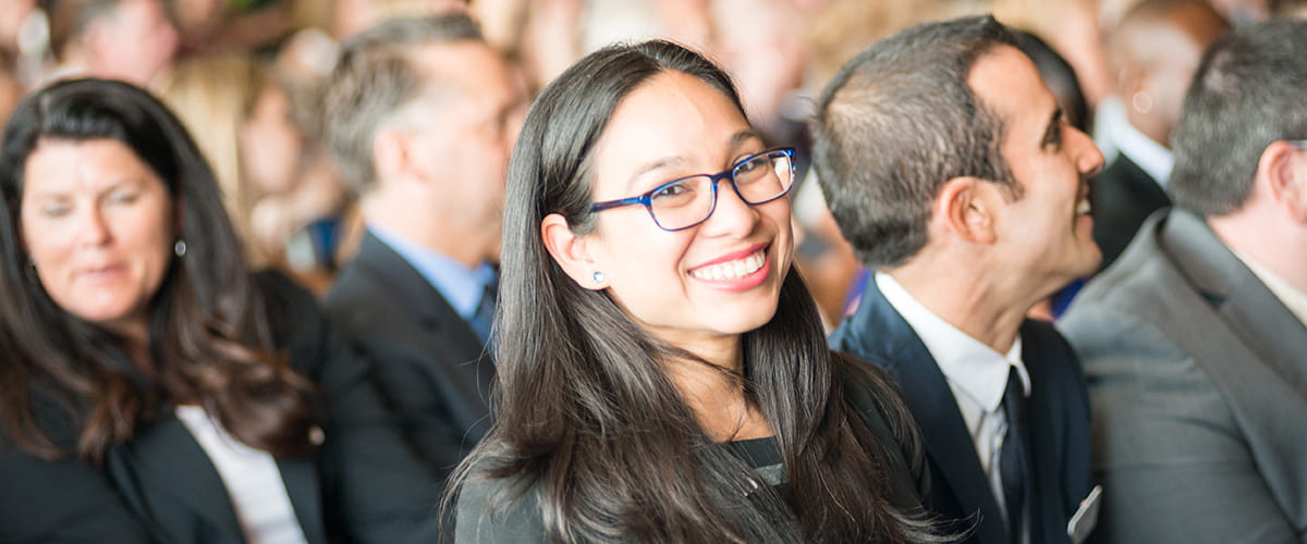 Student smiling at EMBA graduation ceremony