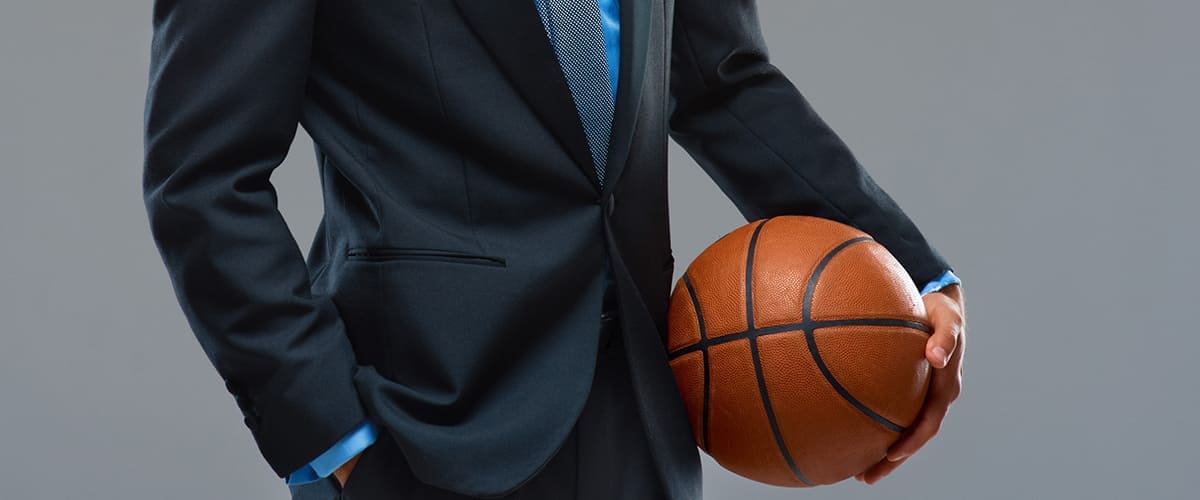 Man in suit holding a basketball