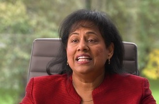 Geeth Chettiar seated indoors speaking during an interview. 