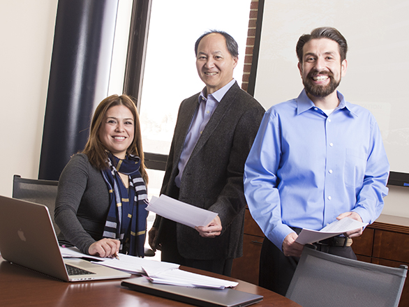 Three members of the Accounting department working in a conference room.