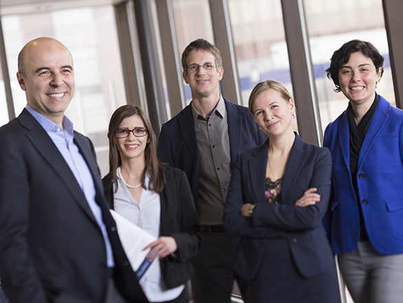 Five members of the Economics department smiling in a group.