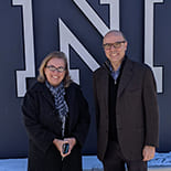 Muge Akpinar-Elci and Mehmet Serkan Tosun stand together in front of the Nevada "N" statue on campus