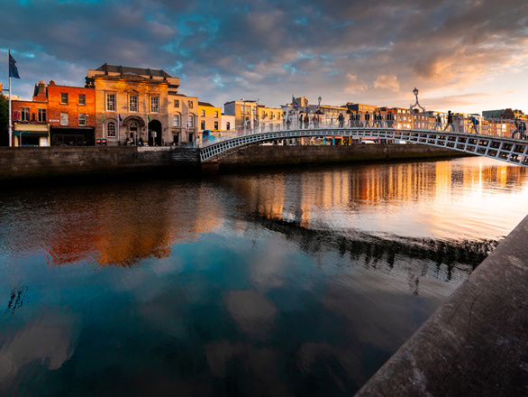Ha'penny Bridge over river Liffey during sunset in Dublin, Ireland