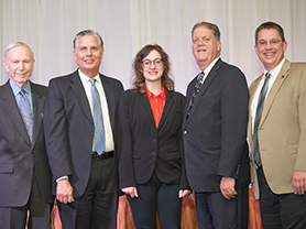 Chester Newland, Gregory Mosier, Isabella F. Kline, Sterling Franklin and Frederick Steinmann posing together on stage. 