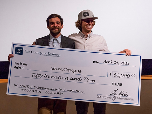 The 2019 Sontag Entrepreneurship Competition winners, Sturn Designs, smiling and holding their winner's check.
