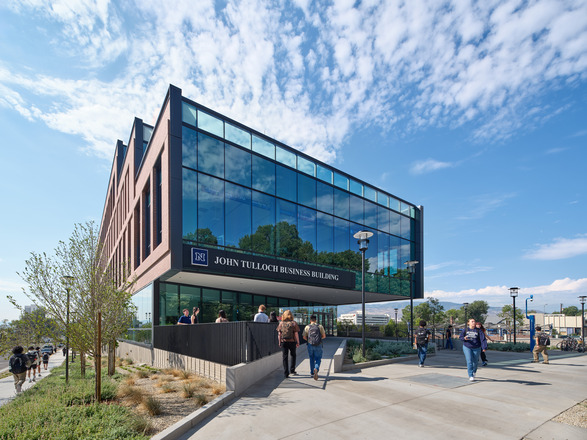 Exterior photo of Ansari Business Building. The windows read "Think Business."