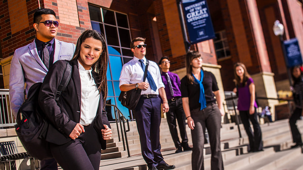 Business students in professional attire outside of the Knowledge Center