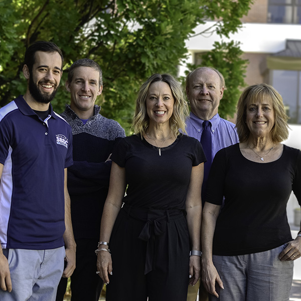 Five members of the Nevada Small Business Development Center stand together outdoors.