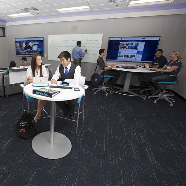 Inside the Ozmen Center with multiple people working in teams at various workstations.