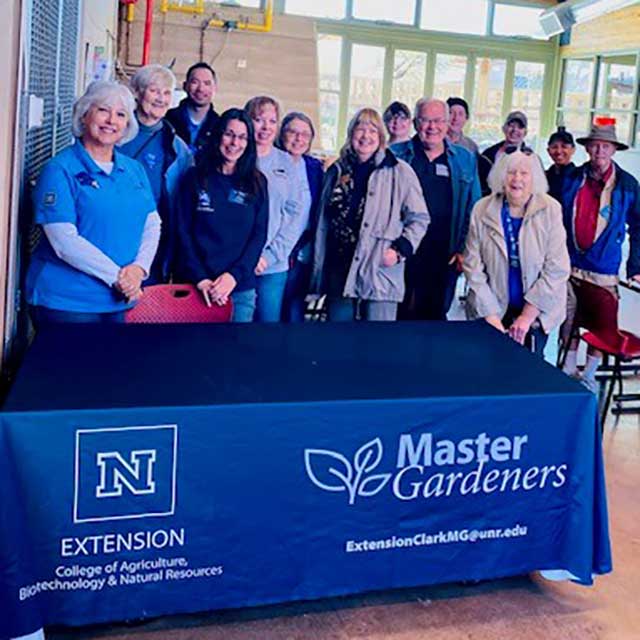 A group of Master Gardener Volunteers at a Master Gardener booth.