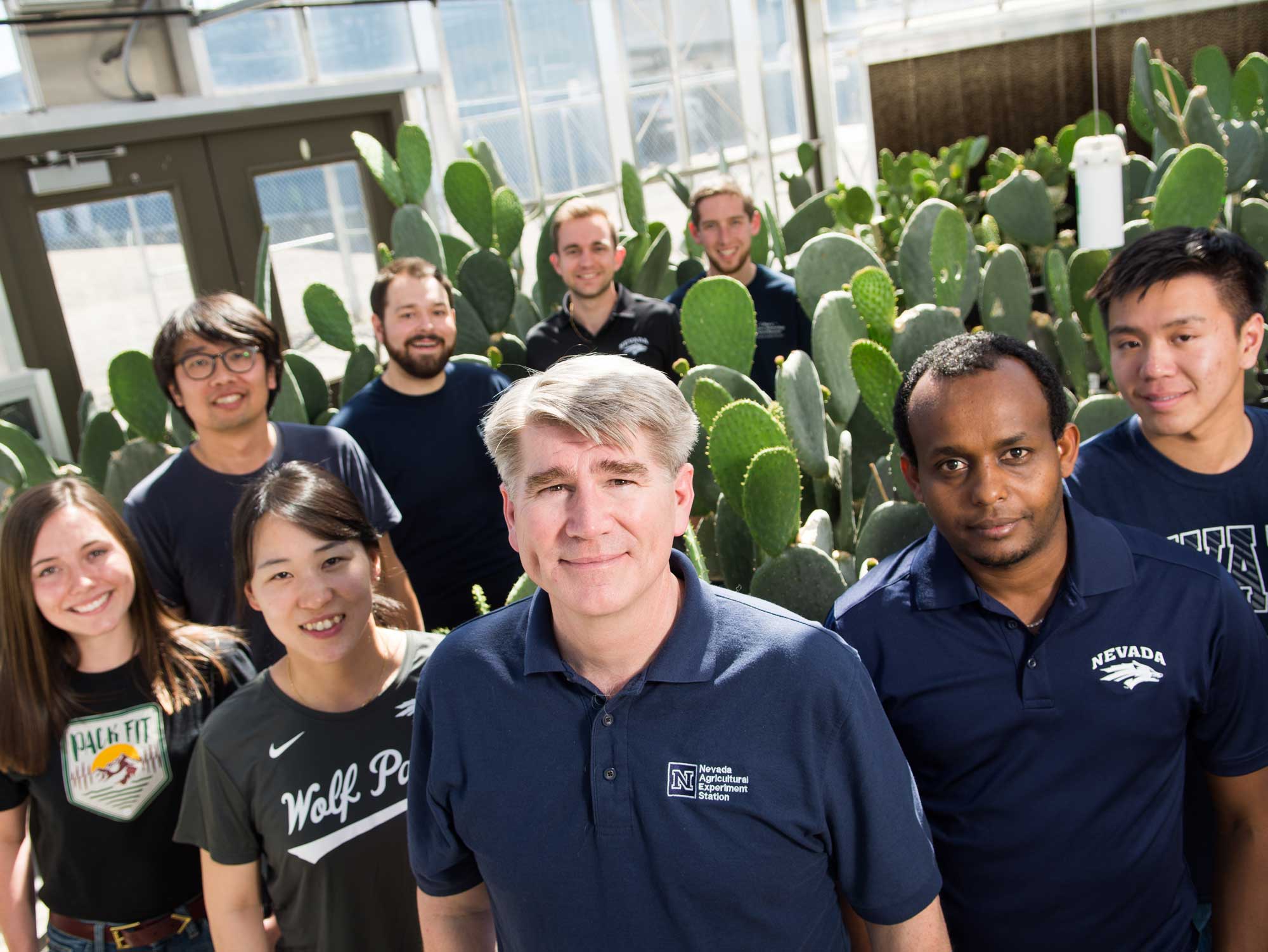 Biotechnology students and faculty with research plants