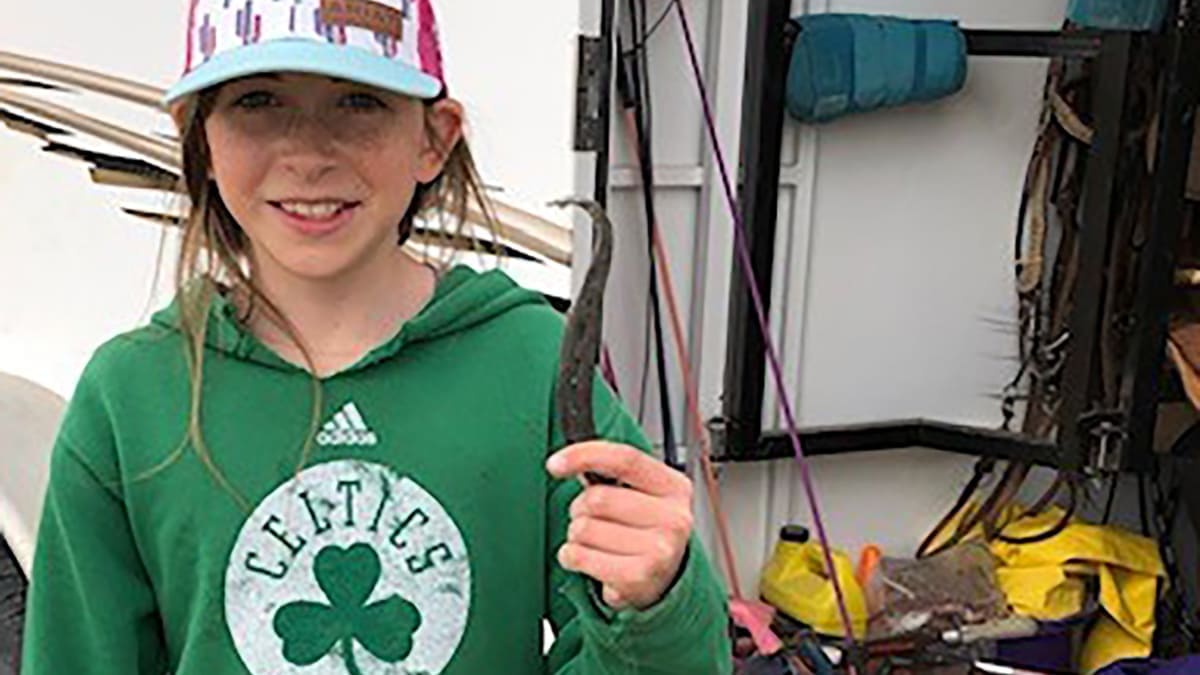 4-H girl showing off horse hoof pick