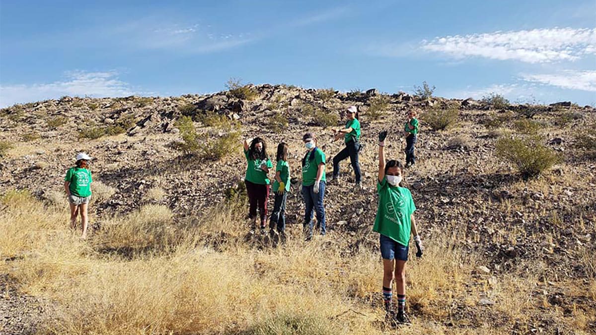 4-H youth clearing trash out of the desert