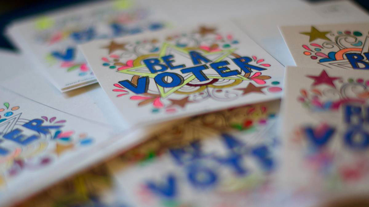 Colorful sticker with the words 'Be a voter'