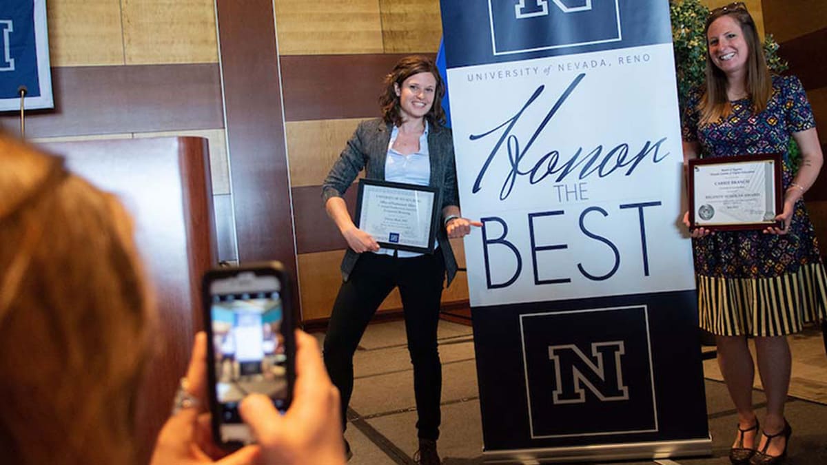 Two award recipients at 2018 ceremony posing with Honer the Best photo