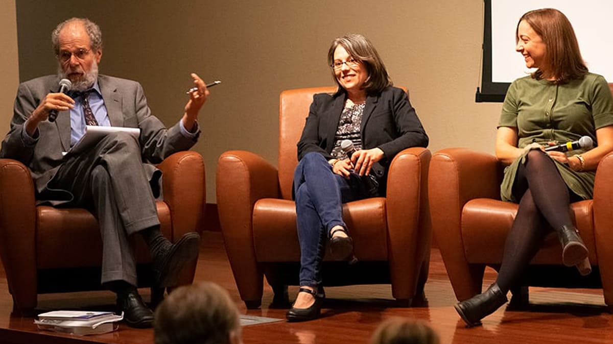 Peter Laufer, Stephanie McAfee and Vanessa Serrao in chairs