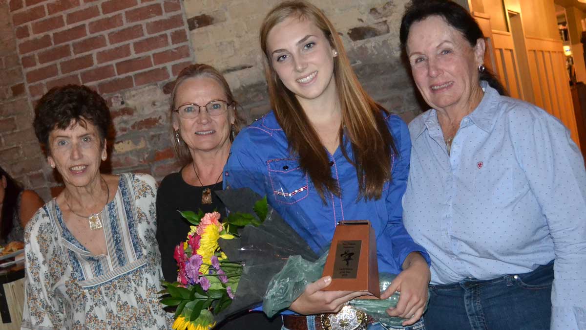 Elisabeth Watkins with award standing with previous three CowBelles