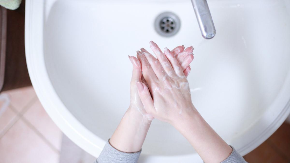 hands getting washed in a sink
